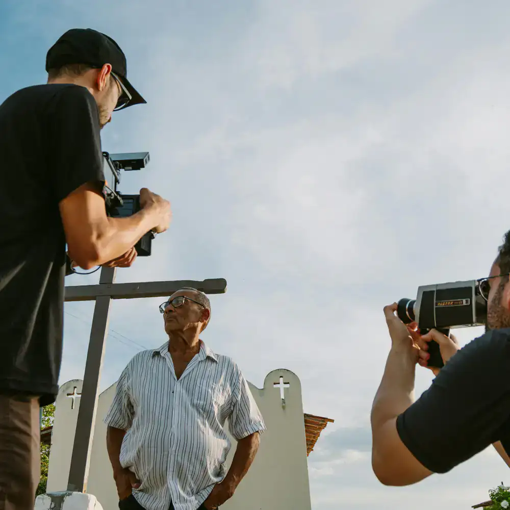 Documentary filmmaker interviewing an elderly storyteller.